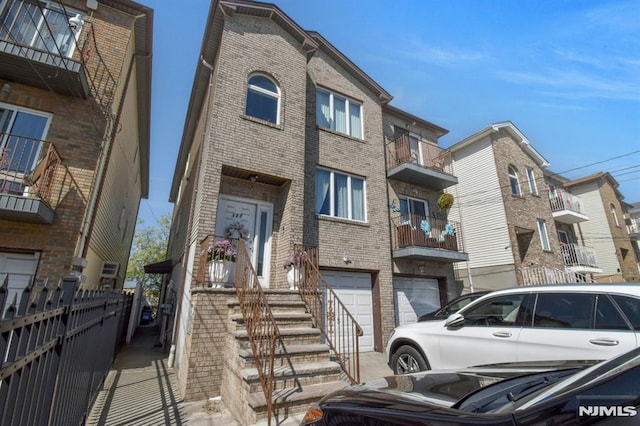 127 Brill St, Newark, NJ 07105 - multi unit property with brick siding, an attached garage, and fence