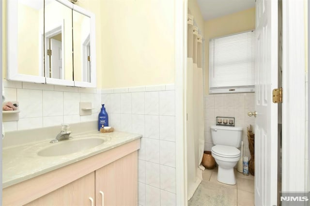 127 Brill St, Newark, NJ 07105 - bathroom with toilet, tile walls, vanity, tile patterned floors, and wainscoting