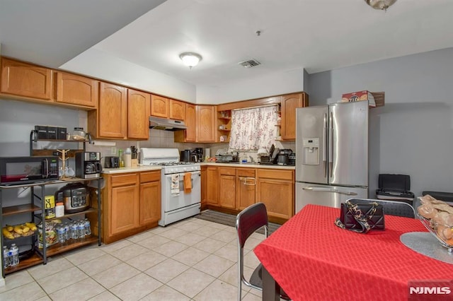 127 Brill St, Newark, NJ 07105 - kitchen featuring white gas stove, stainless steel fridge with ice dispenser, under cabinet range hood, open shelves, and light tile patterned flooring