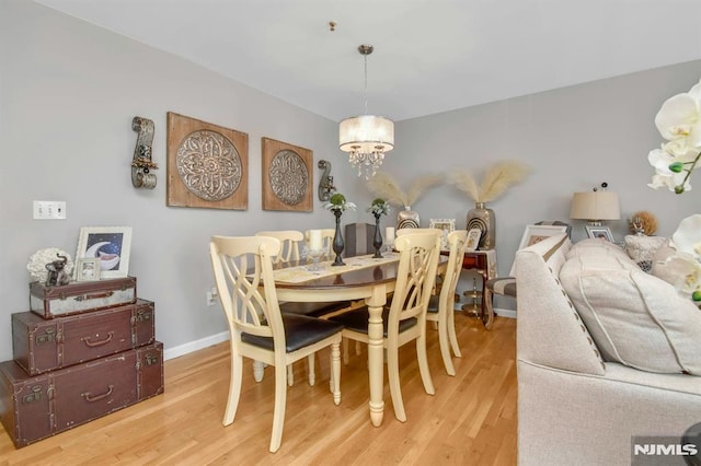127 Brill St, Newark, NJ 07105 - dining space featuring a chandelier, wood finished floors, and baseboards