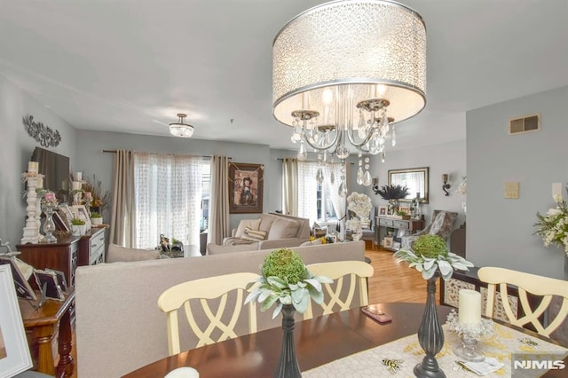 127 Brill St, Newark, NJ 07105 - dining space with a chandelier and wood finished floors