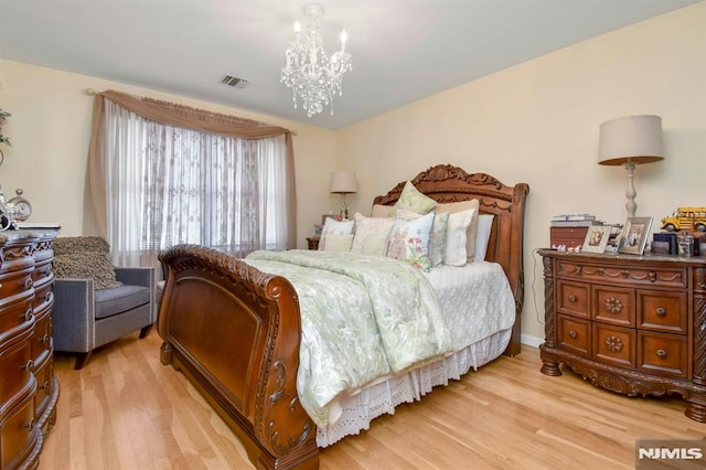 127 Brill St, Newark, NJ 07105 - bedroom featuring light wood-type flooring and a chandelier