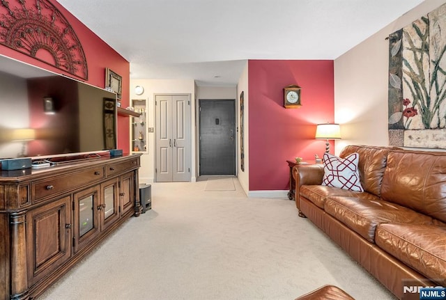 living room with light colored carpet and baseboards