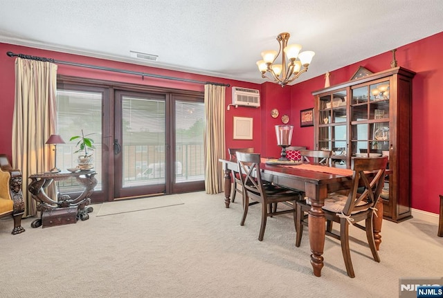 dining area with a chandelier, light carpet, a wall mounted AC, and a textured ceiling