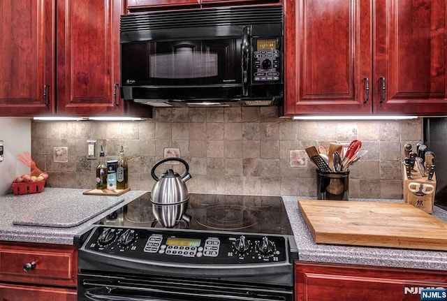kitchen featuring black appliances, dark brown cabinets, decorative backsplash, and light countertops