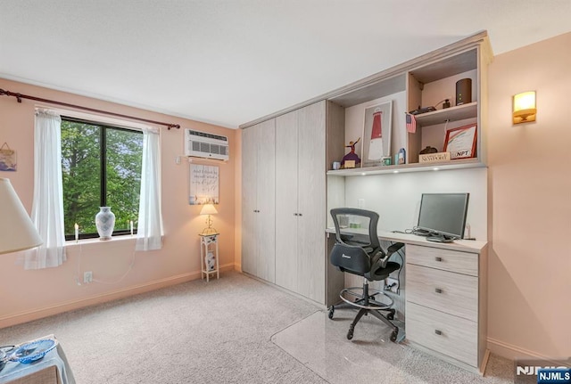 carpeted home office featuring a wall unit AC and baseboards
