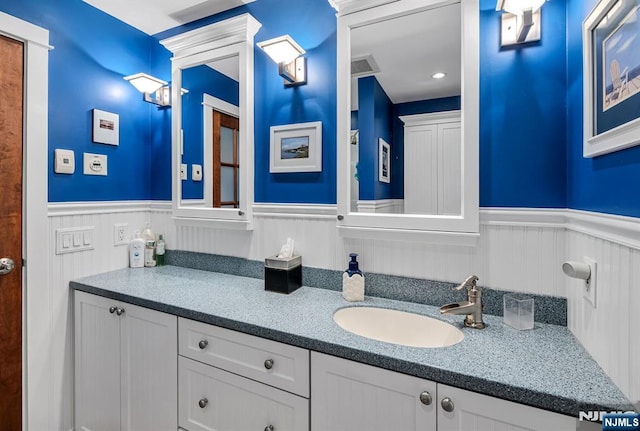 bathroom featuring a wainscoted wall and vanity