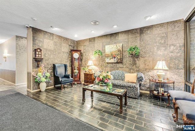 lobby featuring a textured ceiling, a security system, and recessed lighting