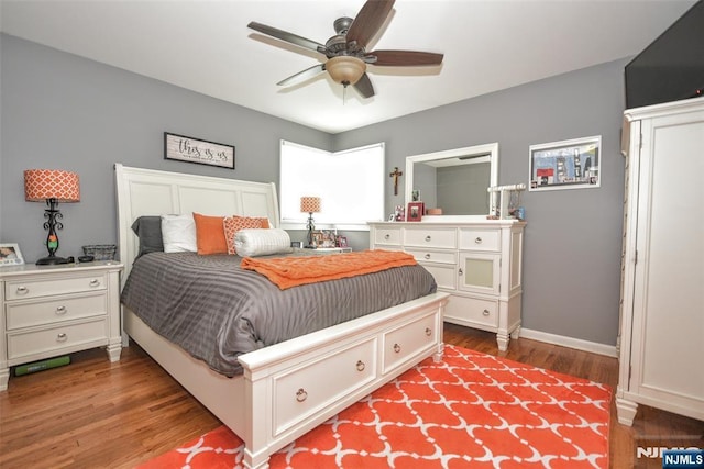 bedroom featuring wood finished floors, baseboards, and a ceiling fan