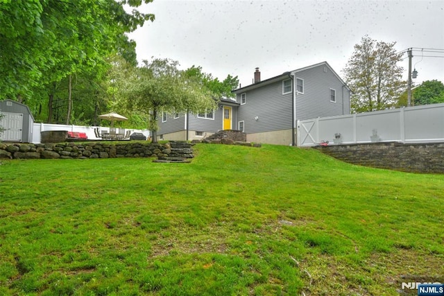 view of yard with a storage shed and an outbuilding