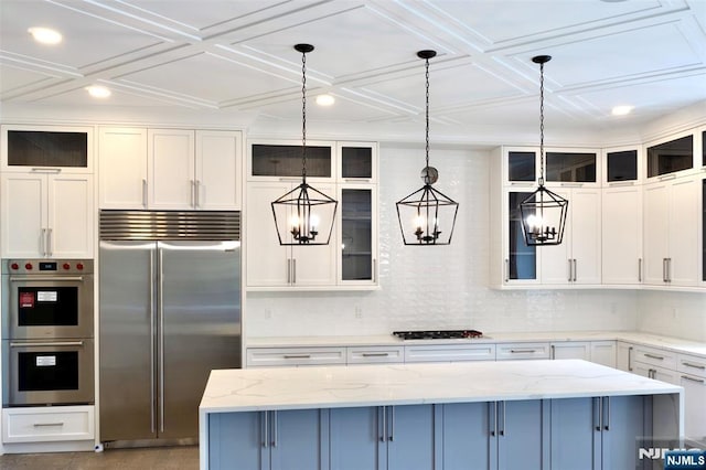 kitchen with stainless steel appliances, white cabinetry, pendant lighting, recessed lighting, and coffered ceiling