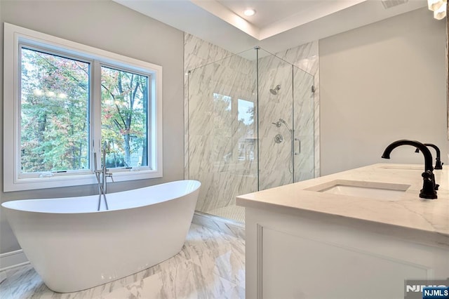 bathroom featuring a marble finish shower, a soaking tub, marble finish flooring, vanity, and recessed lighting