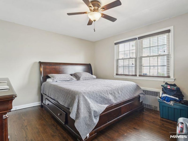 bedroom featuring radiator heating unit, wood finished floors, baseboards, and a ceiling fan
