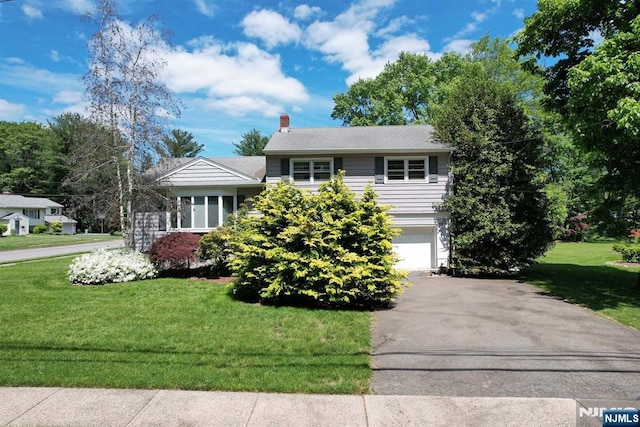 36 Joyce Ln, Wayne, NJ 07470 - view of front of home with a front lawn, a garage, driveway, and a chimney