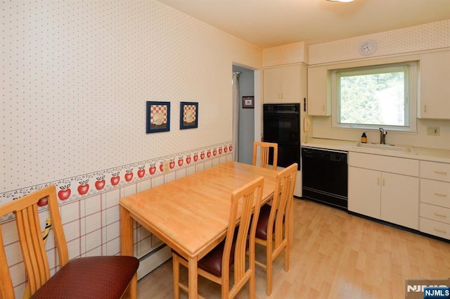 36 Joyce Ln, Wayne, NJ 07470 - kitchen featuring black appliances, a sink, light countertops, wallpapered walls, and light wood-type flooring
