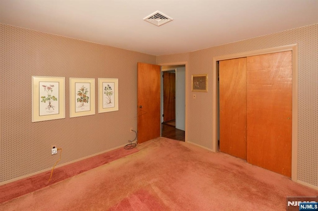 36 Joyce Ln, Wayne, NJ 07470 - unfurnished bedroom featuring carpet flooring, a closet, and wallpapered walls