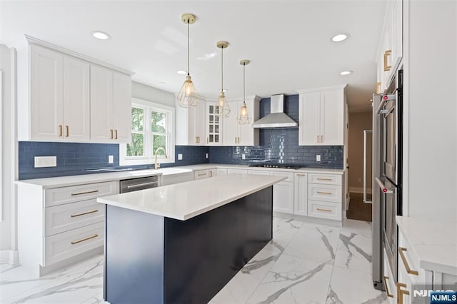 kitchen featuring wall chimney exhaust hood, light marble finish floors, recessed lighting, and white cabinets