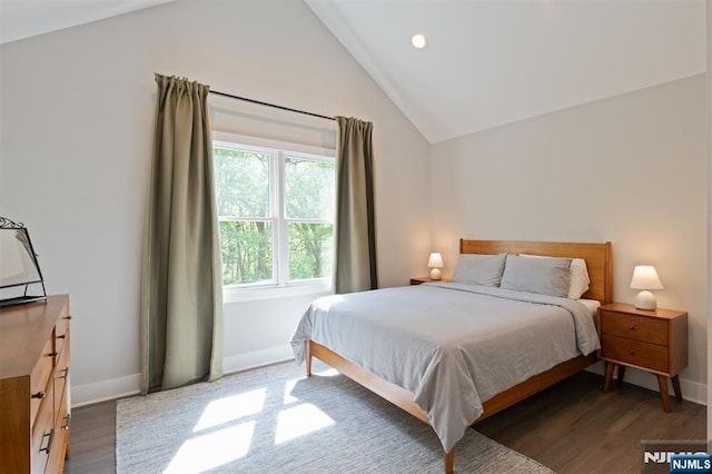 bedroom with lofted ceiling, wood finished floors, baseboards, and recessed lighting