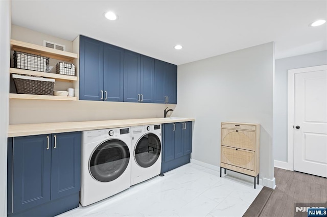 clothes washing area featuring cabinet space, separate washer and dryer, baseboards, and recessed lighting