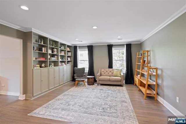 sitting room featuring ornamental molding, wood finished floors, baseboards, and recessed lighting