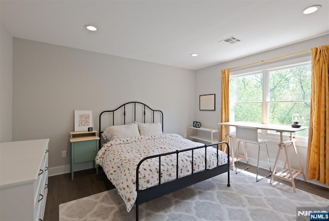 bedroom featuring wood finished floors, baseboards, and recessed lighting