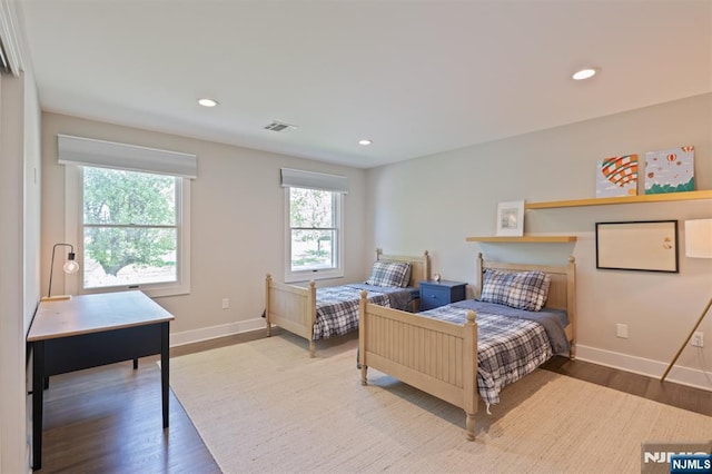 bedroom with wood finished floors, baseboards, and recessed lighting