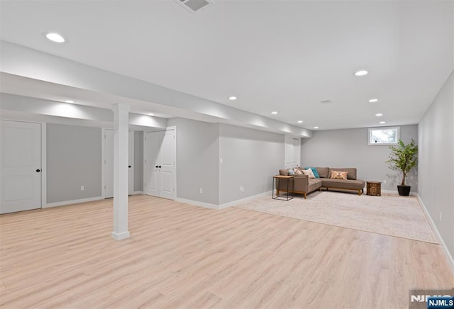 living area with light wood finished floors, recessed lighting, and baseboards