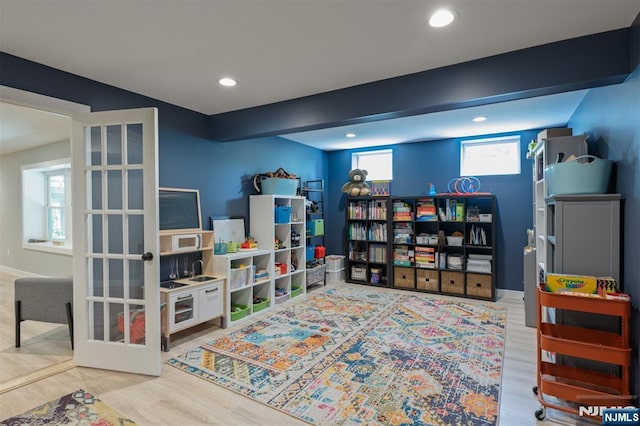 playroom with recessed lighting, wood finished floors, and french doors