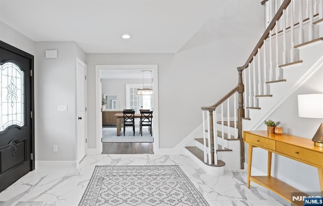 entrance foyer featuring recessed lighting, stairs, marble finish floors, and baseboards