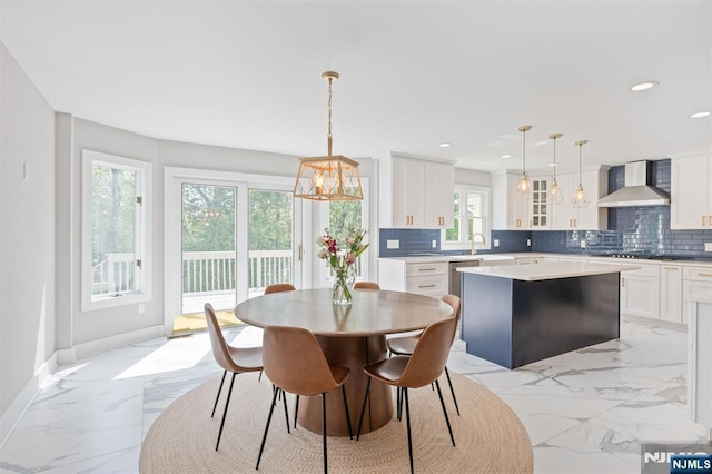 dining room with light marble finish floors, a chandelier, baseboards, and recessed lighting