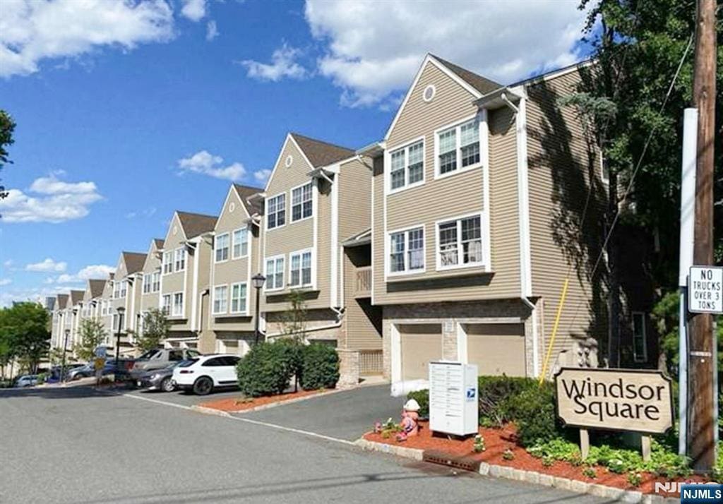 520 Windsor, Palisades Park, NJ 07650 - view of building exterior with a residential view, an attached garage, and driveway