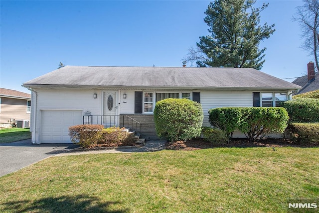 single story home with an attached garage, a front lawn, driveway, and central AC