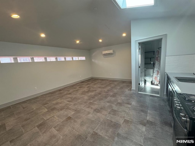 6115 Kennedy Blvd, West New York, NJ 07093 - below grade area featuring recessed lighting, a wall mounted AC, baseboards, and a sink