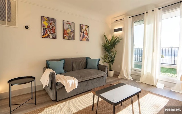 6115 Kennedy Blvd, West New York, NJ 07093 - living area featuring wood finished floors, plenty of natural light, and baseboards