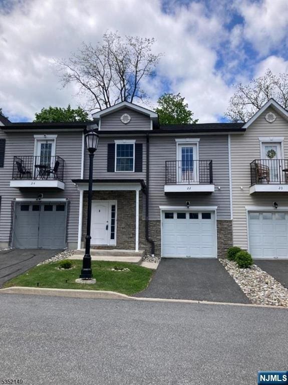 22 Joseph Dr, Newton, NJ 07860 - view of property with a balcony, driveway, and stone siding