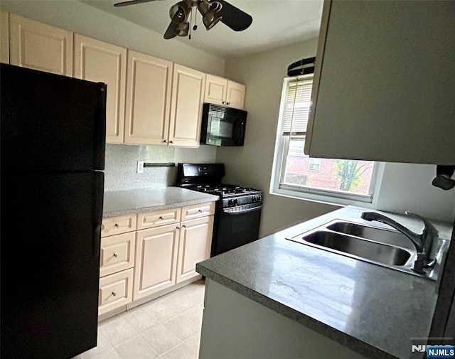 1481 E Terrace Cir Unit 4, Teaneck, NJ 07666 - kitchen with black appliances, a sink, a ceiling fan, light tile patterned floors, and white cabinets