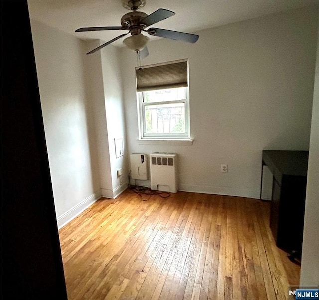 1481 E Terrace Cir Unit 4, Teaneck, NJ 07666 - unfurnished room featuring radiator, light wood-style flooring, and a ceiling fan