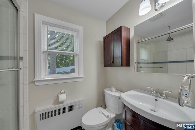 full bathroom with radiator, a stall shower, vanity, and toilet