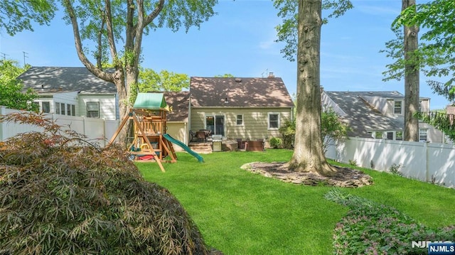 rear view of house with a playground
