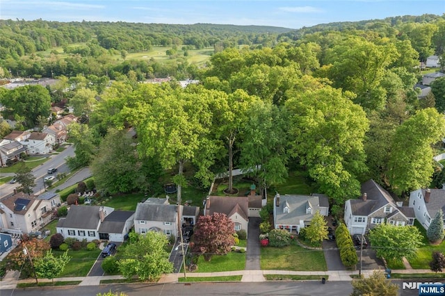 aerial view of residential area with a heavily wooded area