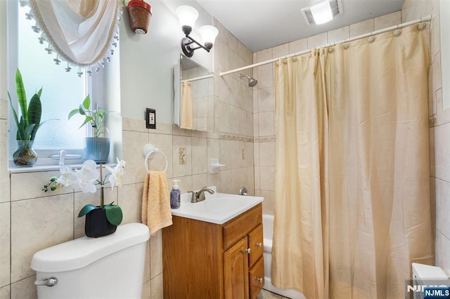 bathroom featuring tile walls, toilet, shower / bath combo, and vanity