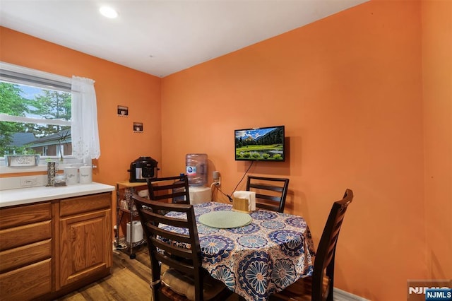 dining space with wood finished floors
