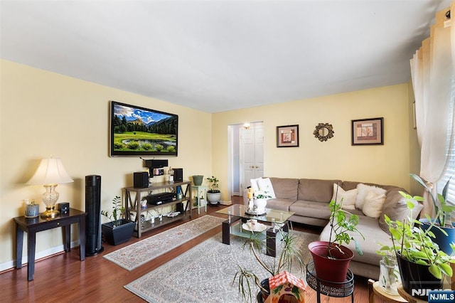 living room featuring dark wood-style floors and baseboards