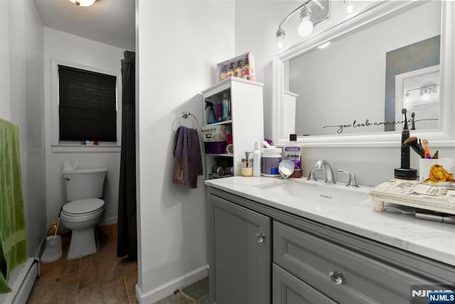 86 Fairview Ave, Teaneck, NJ 07666 - bathroom with baseboard heating, vanity, toilet, baseboards, and tile patterned flooring
