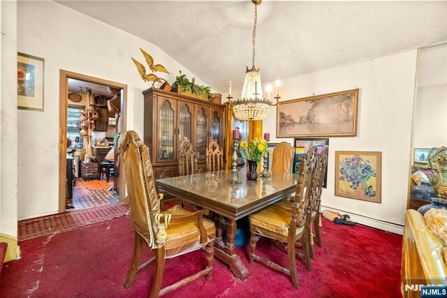 86 Fairview Ave, Teaneck, NJ 07666 - carpeted dining room with a chandelier, a baseboard radiator, and vaulted ceiling