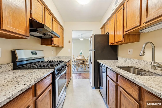 825 Riverside Unit 204, Lyndhurst, NJ 07071 - kitchen with stainless steel range with gas stovetop, under cabinet range hood, a sink, ceiling fan, and black dishwasher