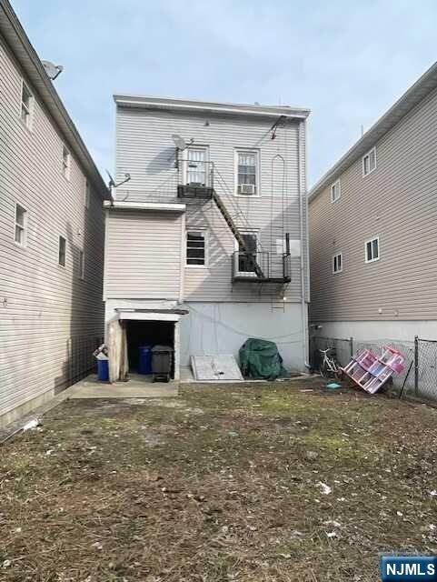back of house with fence