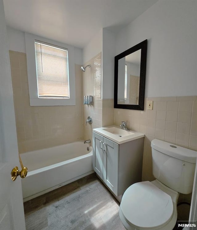 458-460 Leslie St, Newark, NJ 07112 - full bath with tile walls, toilet, bathing tub / shower combination, vanity, and wood finished floors