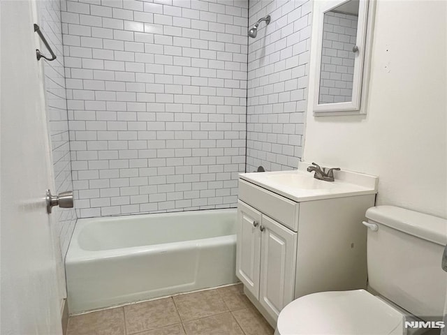 bathroom featuring toilet, shower / tub combination, vanity, and tile patterned floors