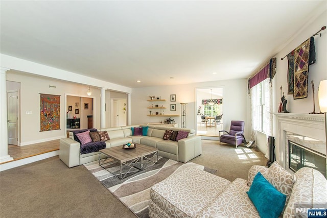 39 Crown View Ct, Sparta, NJ 07871 - carpeted living room with a fireplace, ornate columns, and baseboards